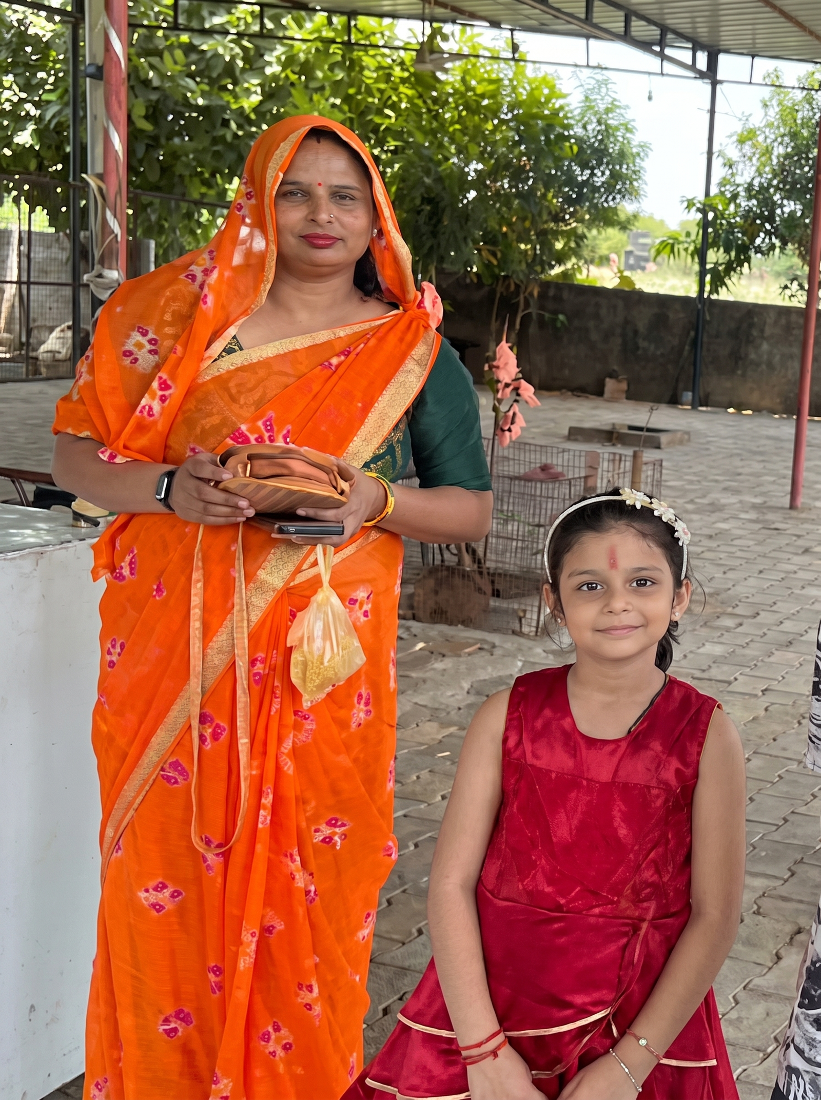 Minakshi Mam in radiant saffron bandhej saree